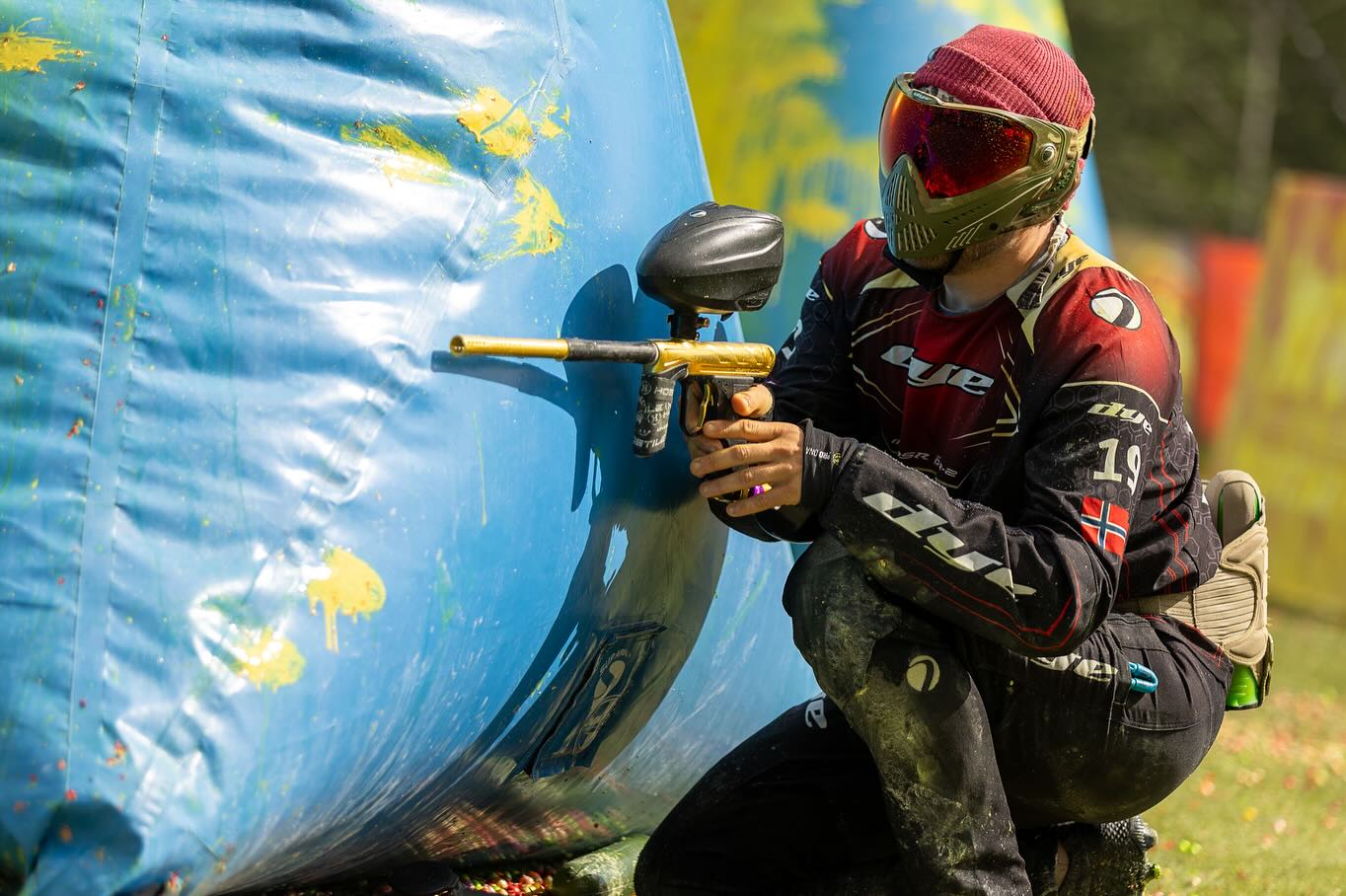 Paintball-Spieler hinter Deckung auf einem Paintball-Feld
